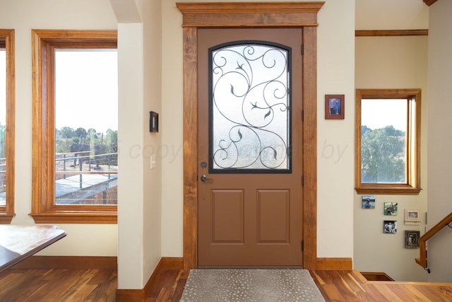 entryway with baseboards, stairway, and dark wood-type flooring