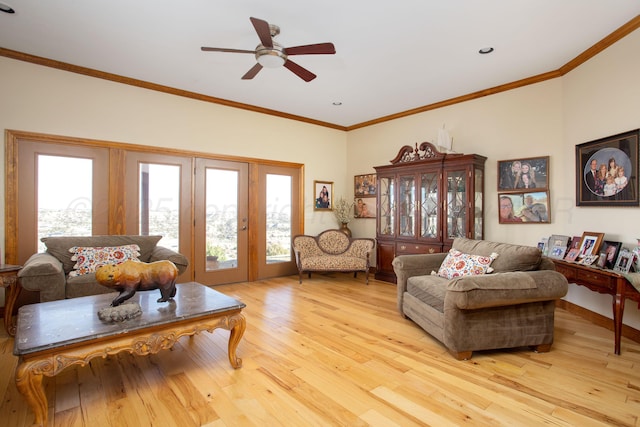 living area with french doors, ornamental molding, a ceiling fan, and light wood-style flooring