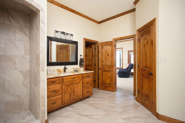full bath featuring crown molding, a tile shower, and vanity