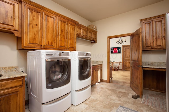 laundry room with cabinet space, baseboards, and washer and dryer