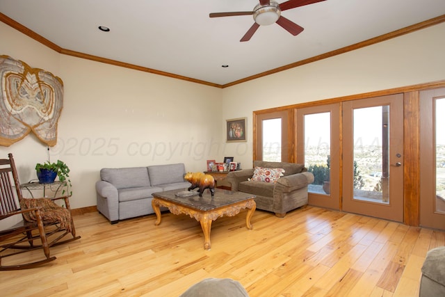 living area featuring a ceiling fan, ornamental molding, and light wood finished floors