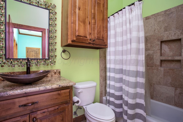 full bath featuring vanity, shower / bath combo, and toilet