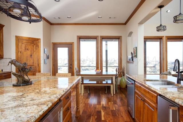 kitchen featuring light stone counters, a sink, dark wood-style flooring, and visible vents