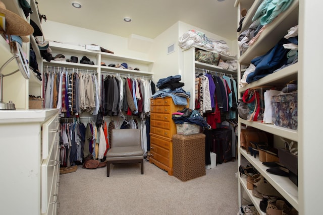 walk in closet featuring visible vents and carpet