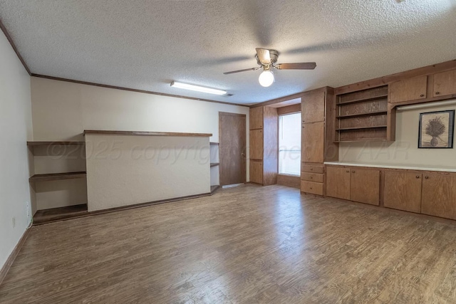 5708 S Fannin St, Amarillo, TX 79110 - spare room with light wood-style floors, a ceiling fan, a textured ceiling, and crown molding