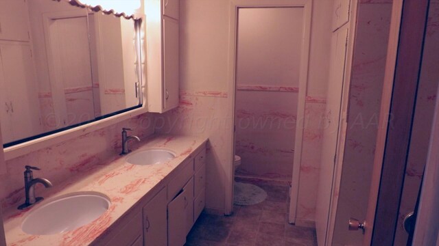 bathroom with tile patterned floors, vanity, and toilet