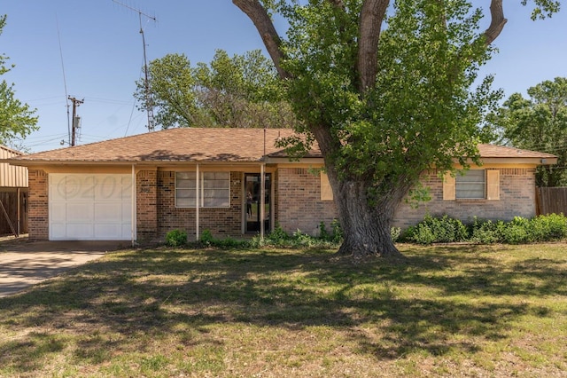 single story home featuring a front lawn, concrete driveway, brick siding, and an attached garage