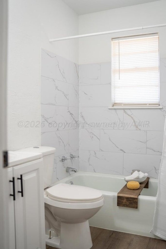 bathroom with shower / bath combo, toilet, and wood finished floors