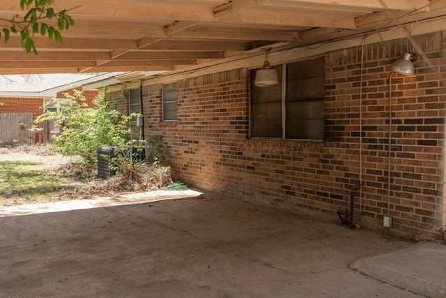 exterior space with a patio and brick siding