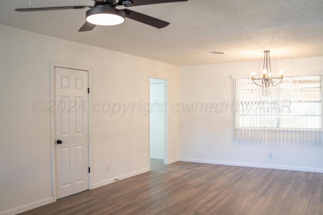 empty room featuring dark wood-style floors, a textured ceiling, and baseboards