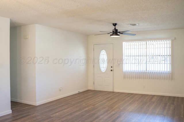 entryway with dark wood-style floors, visible vents, baseboards, and a ceiling fan