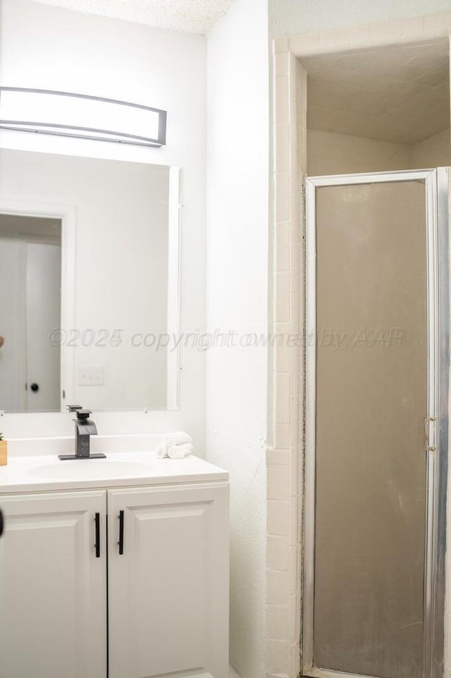 full bath with a shower stall and vanity