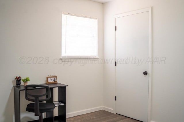 interior space with baseboards and dark wood-type flooring