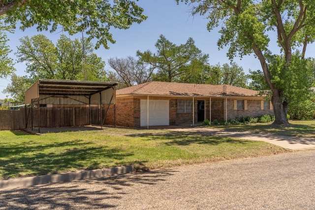 view of front of home with a carport, brick siding, driveway, and a front lawn