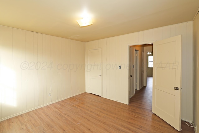 unfurnished room with hardwood / wood-style floors