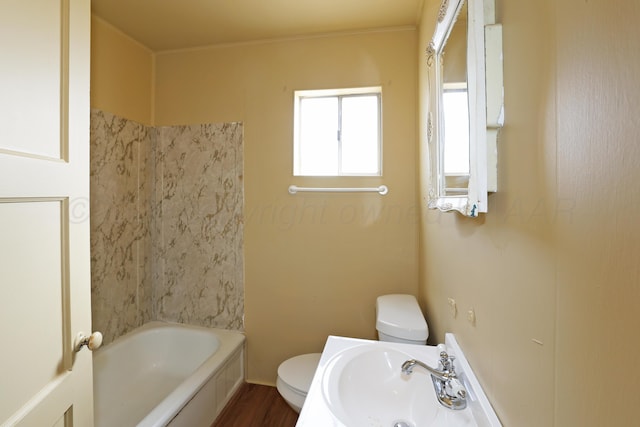 full bathroom featuring wood-type flooring, bathing tub / shower combination, toilet, and sink