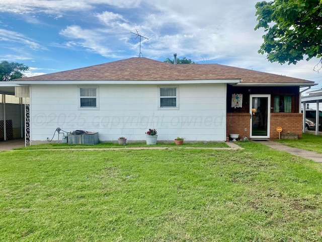 928 Elmore St, Borger, TX 79007 - back of property with a lawn, roof with shingles, and brick siding