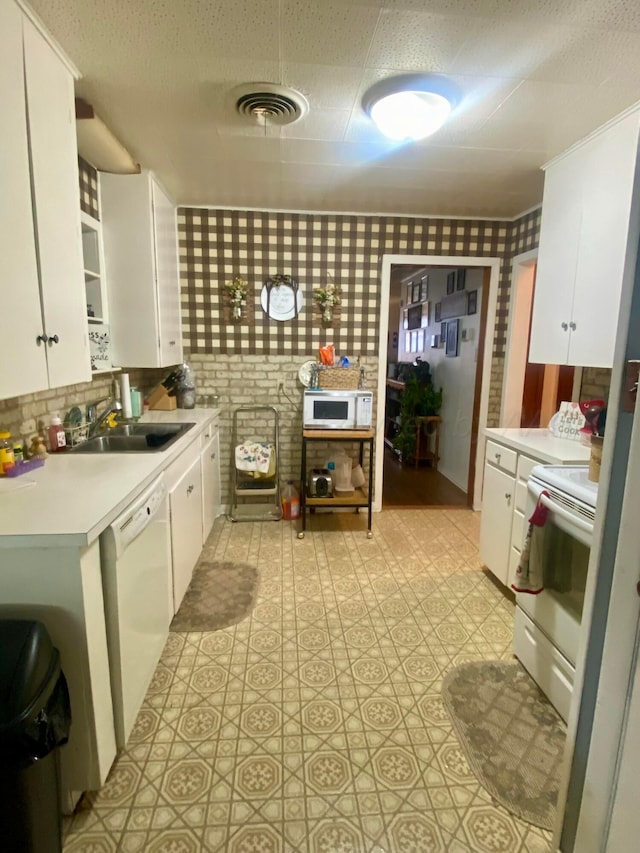 928 Elmore St, Borger, TX 79007 - kitchen with white appliances, light countertops, white cabinetry, backsplash, and light flooring