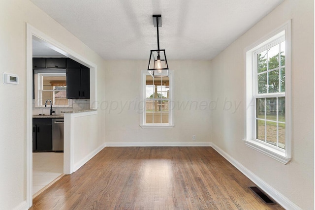 3201 S Grand St, Amarillo, TX 79103 - unfurnished dining area featuring wood finished floors and plenty of natural light