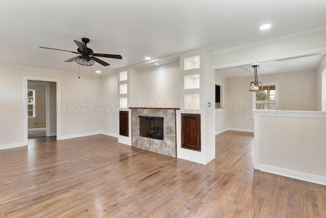 3201 S Grand St, Amarillo, TX 79103 - unfurnished living room with a fireplace, wood finished floors, a ceiling fan, ornamental molding, and recessed lighting