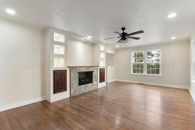 3201 S Grand St, Amarillo, TX 79103 - unfurnished living room featuring wood finished floors, a fireplace, a ceiling fan, recessed lighting, and ornamental molding