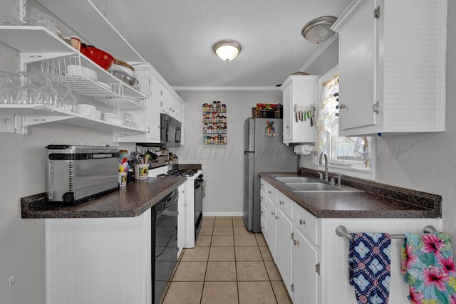 kitchen with dark countertops, a sink, white cabinetry, and black appliances
