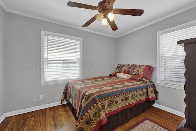 bedroom with ceiling fan, wood finished floors, baseboards, and ornamental molding