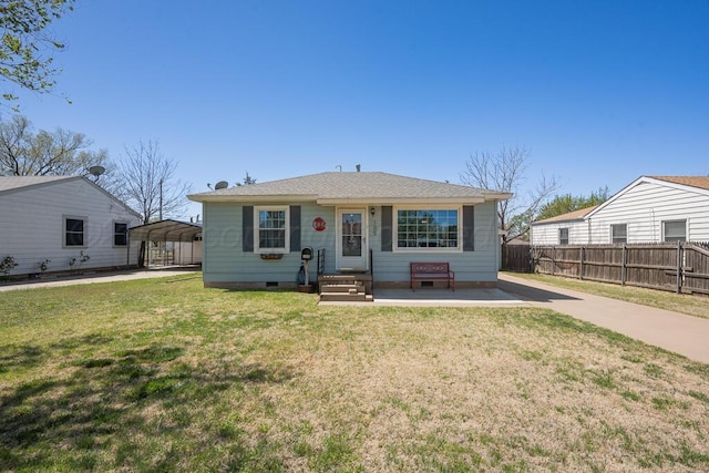 bungalow-style house featuring fence, crawl space, a front lawn, and a detached carport