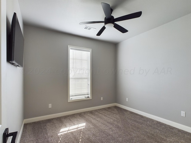 carpeted empty room featuring visible vents, baseboards, and a ceiling fan
