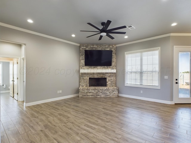 unfurnished living room with wood finished floors, ceiling fan, visible vents, and plenty of natural light