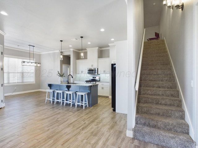 stairway featuring wood finished floors, baseboards, ornamental molding, and recessed lighting