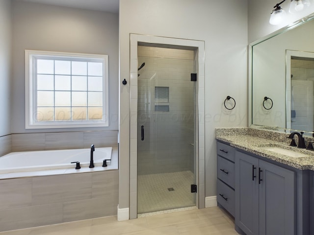 full bathroom with vanity, a stall shower, and a garden tub