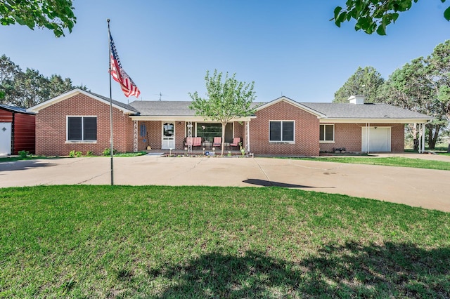 ranch-style home featuring a garage, a front lawn, and covered porch