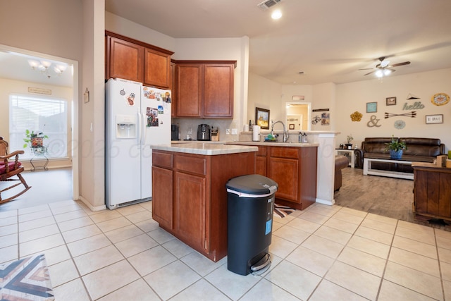 1405 SW 61st Ave, Amarillo, TX 79118 - kitchen with white fridge with ice dispenser, open floor plan, light countertops, a center island, and a ceiling fan