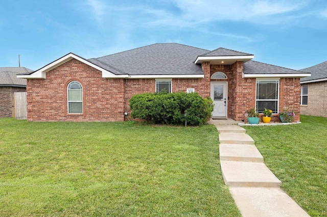 1405 SW 61st Ave, Amarillo, TX 79118 - view of front of home featuring a front lawn, roof with shingles, and brick siding