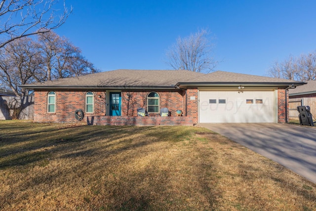 ranch-style home featuring a garage, concrete driveway, brick siding, and a front yard