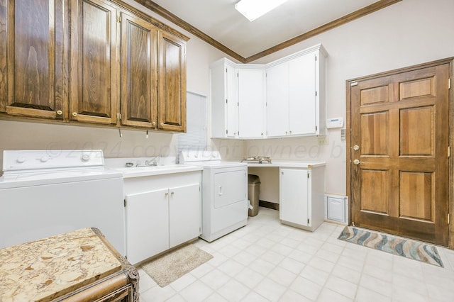 laundry area featuring cabinets, sink, washer and dryer, and ornamental molding