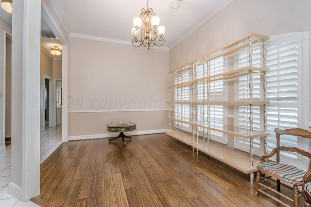 interior space featuring hardwood / wood-style floors, a notable chandelier, and ornamental molding