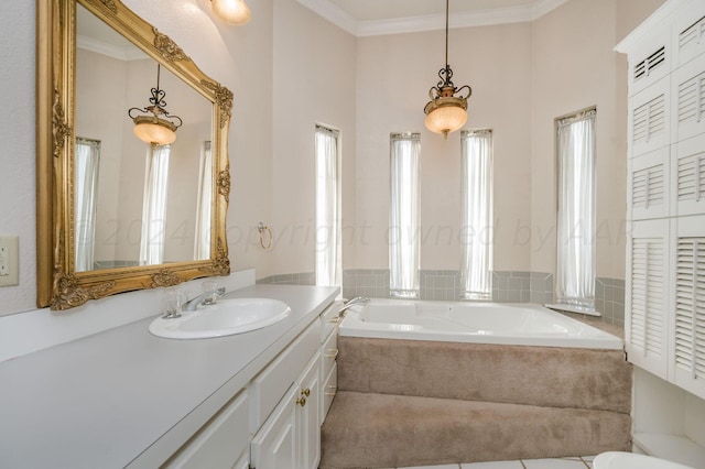 bathroom featuring tiled bath, vanity, and ornamental molding