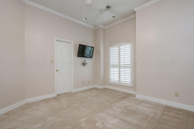 carpeted empty room featuring ceiling fan and crown molding