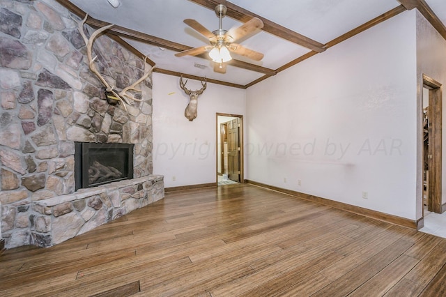 unfurnished living room featuring beamed ceiling, hardwood / wood-style flooring, ceiling fan, and a fireplace