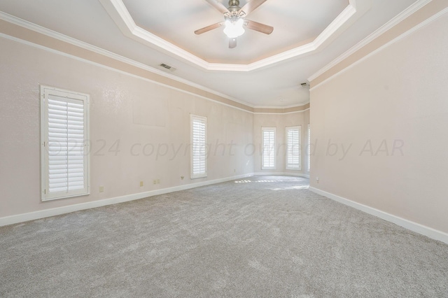 unfurnished room featuring crown molding, carpet flooring, ceiling fan, and a raised ceiling