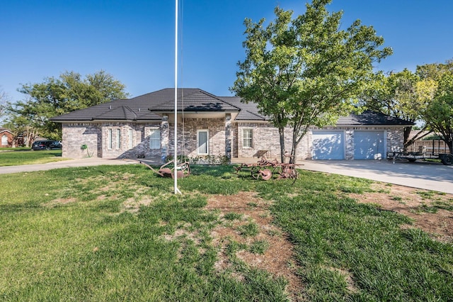 single story home featuring a garage and a front yard