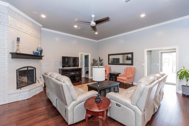 4511 Spartanburg Dr, Amarillo, TX 79119 - living room featuring a ceiling fan, crown molding, a fireplace, dark wood-style floors, and recessed lighting