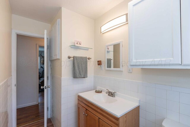 1102 Franklin Ave, Panhandle, TX 79068 - half bath with tile walls, vanity, and a wainscoted wall