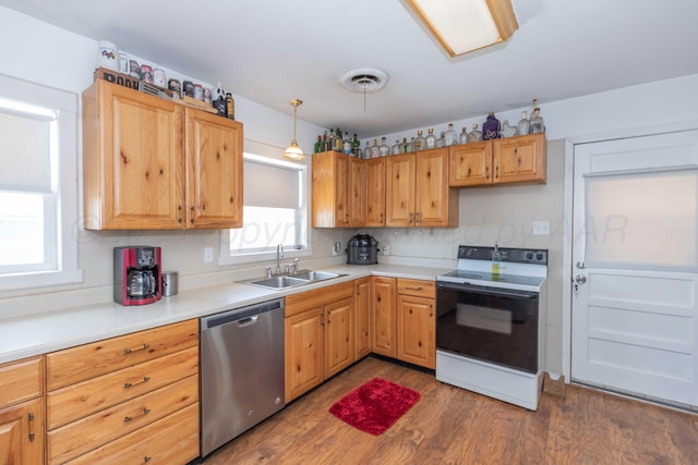 1102 Franklin Ave, Panhandle, TX 79068 - kitchen with white electric stove, stainless steel dishwasher, dark wood-style floors, and light countertops