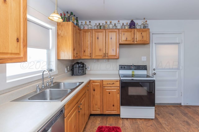 1102 Franklin Ave, Panhandle, TX 79068 - kitchen with white electric range, dark wood-type flooring, light countertops, hanging light fixtures, and stainless steel dishwasher