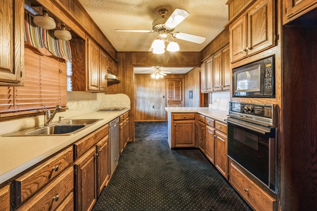 kitchen with oven, sink, dishwasher, and a textured ceiling