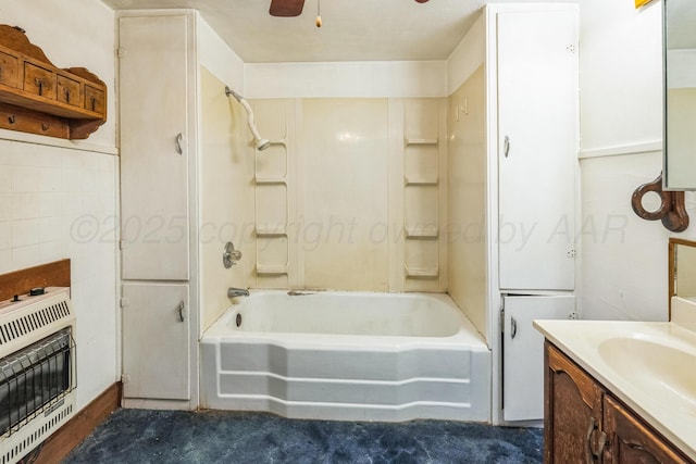 bathroom with heating unit, vanity, bathtub / shower combination, and ceiling fan