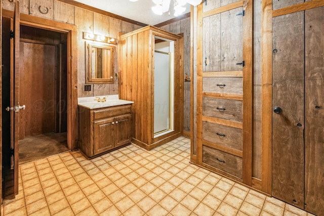 bathroom with vanity and wood walls